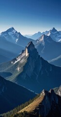 Aufkleber - A breathtaking mountain range unfolds under a clear blue sky, with snow-capped peaks and a rugged terrain dotted with trees and shrubs