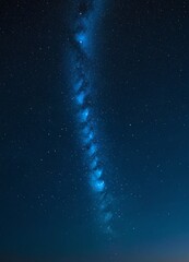 Poster - The Milky Way galaxy stretches across the night sky, its spiral arms glowing in shades of blue and white against the dark backdrop