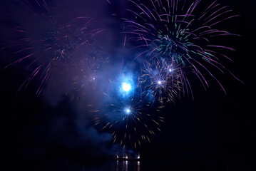 Wall Mural - Fireworks, blue night fireworks on black sky background