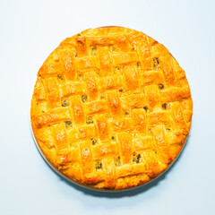 American pie with baked crust on blue background