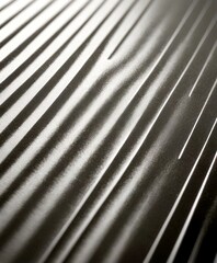 Poster - a close-up view metallic surface with a repeating pattern of diagonal lines, creating a sense of movement and texture