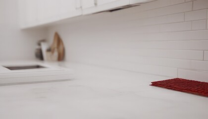 Poster - A white kitchen counter with a red woven mat and a wooden cutting board on the left side