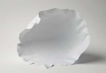 Leinwandbilder - A white paper sheet is crumpled and tilted to the right, creating a dynamic and abstract composition against a plain white background