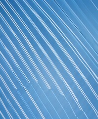 Poster - a diagonal pattern of white lines against a blue background, creating a sense of movement and rhythm
