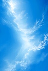 Aufkleber - A serene blue sky with fluffy white clouds, where the sun's rays are shining through the top left corner, creating a beautiful and peaceful atmosphere