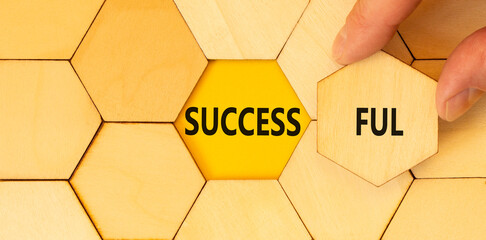 Successful symbol. Concept word Successful on beautiful wooden puzzles. Beautiful yellow background. Businessman hand. Business successful concept. Copy space.