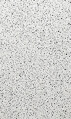 Poster - A close-up view white surface with a pattern of black dots, resembling a speckled or speckled texture