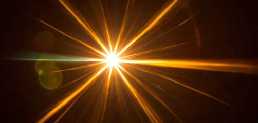 Leinwandbilder - A bright, radiant star shines against a dark background, with a lens flare visible in the bottom left corner