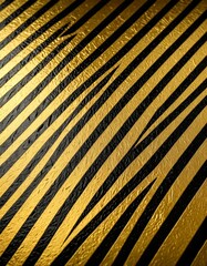Aufkleber - a close-up view textured surface with diagonal lines in black and gold, creating a striking pattern