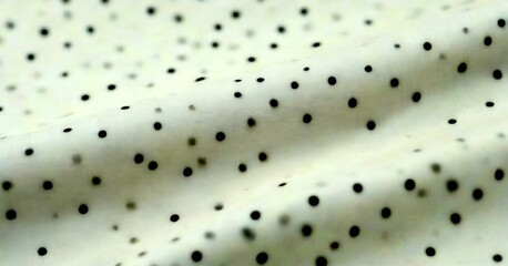 Aufkleber - A close-up view fabric with a pattern of small black dots, creating a textured and visually interesting surface