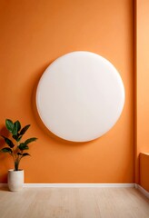 Leinwandbilder - A large white circular light fixture is mounted on an orange wall, with a potted plant to the left and a wooden floor to the right.