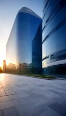 Poster - a modern architectural structure with a curved glass facade reflecting the surrounding cityscape and the setting sun, creating a serene and tranquil atmosphere