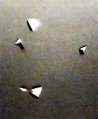 Aufkleber - an abstract representation of four white triangles floating in a dark, textured background.
