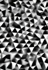 Poster - a black and white abstract pattern composed of numerous small triangles arranged in a random, overlapping manner, creating a visually striking and dynamic composition