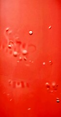 Poster - a close-up view pinkish-red surface with small white dots scattered across it, creating a sense of movement and texture