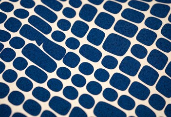 Poster - A close-up view patterned surface, featuring a repeating arrangement of blue and white circles or ovals