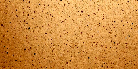 Fototapete - a close-up view textured surface, possibly a stone or concrete wall, with a pattern of small, irregularly shaped holes or dots in various shades of brown