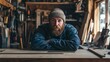 © Wild Dream - Bearded man in cozy woodworking workshop wearing denim jacket and wool hat