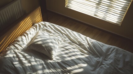 Aufkleber - A birds-eye view of a clean and simple bedroom setup, with a white duvet cover and a single pillow on a wooden bed frame.