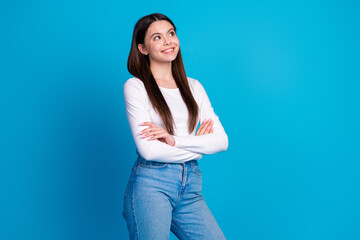 Canvas Print - Photo portrait of pretty teen girl crossed hands confident look empty space wear trendy white outfit isolated on blue color background