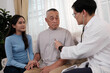 © Success Media - The doctor gives a health check to an Asian grandfather, daughter and grandson.