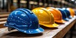 © Ihor - Colorful hard hats are neatly arranged on a wooden table in a construction area