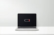 © fad82 - Workspace with laptop computer low battery sign on screen