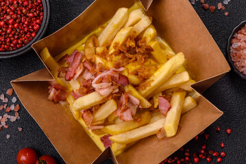 Crispy French fries with pieces of bacon, salt and spices