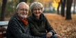 © Iriyalo - Elderly couple smiling warmly while sitting on a park bench in autumn, surrounded by falling leaves and golden trees
