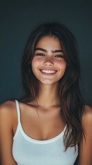 Canvas Print - Smiling young woman in a white tank top with long hair