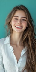 Canvas Print - Smiling woman in a white shirt, long hair, teal background