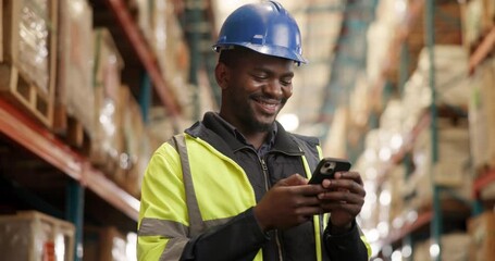 Canvas Print - Black man, cellphone and texting in logistics warehouse for checklist, contractor or shipping or inventory. African person, boxes and engineer with smile on mobile smartphone, supply chain or storage