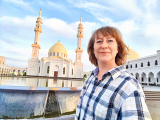 A traveler enjoys her time at the White Mosque in Tatarstan, capturing the beauty of the architecture and surroundings. The adventures of a middle-aged female tourist on a trip