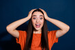 © deagreez - Photo of cheerful glad adorable cute woman wear orange clothes touch head isolated on dark blue color background