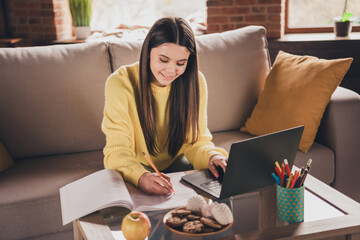 Poster - Photo of charming teen girl sit sofa do homework online wear yellow clothes modern interior flat indoors