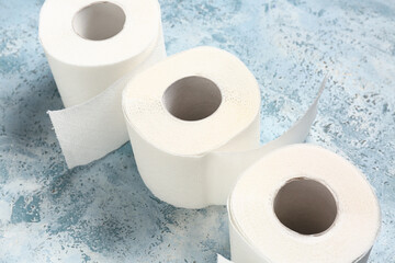 Rolls of toilet paper on blue background