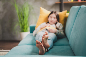 Poster - Full length portrait of charming little girl lying sleep sofa book wear pullover modern interior flat indoors