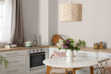 Wall Mural - Vase with beautiful blooming lilac flowers in kitchen