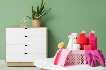 Canvas Print - Basket with cleaning supplies on coffee table at home