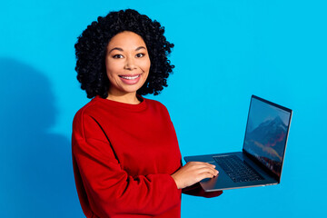 Photo portrait of lovely young lady hold netbook working dressed stylish red garment isolated on blue color background