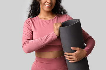 Sticker - Sporty young African-American woman with yoga mat on grey background, closeup