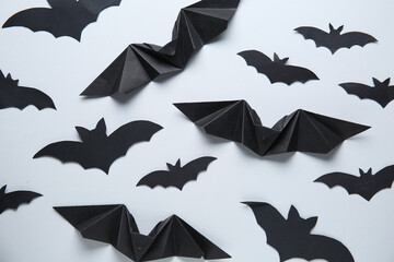 Black paper bats for Halloween party on grey background