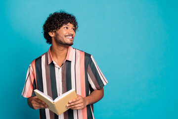 Poster - Portrait of nice young man book look empty space wear shirt isolated on turquoise color background