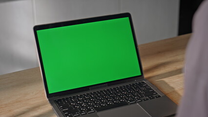 Remote employee looking mockup laptop having video conference at home close up.