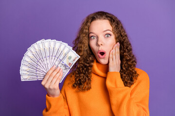 Wall Mural - Photo of nice young girl hold money cash wear pullover isolated on violet color background