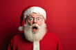 © wolfhound911 - A stunned Santa Claus, looking directly ahead with a shocked expression, his iconic red suit and hat providing a festive contrast to the red backdrop with ample room for copy or holiday greetings.