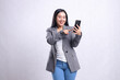 © Ajab - Beautiful young office girl asia cheerful to mobile phone while touching, holding cellphone wearing gray suit isolated on white background. for technology, lifestyle, shopping, transaction content