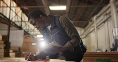 Poster - Black man, carpenter and tablet for planning design in workshop for furniture, manufacturing and renovation. Production, measuring or thinking in factory, engineer and handyman in warehouse for idea