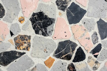 Classic terrazzo texture featuring grey background with rose and beige fragments for retro design appeal