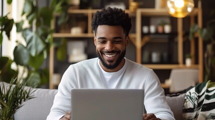 Wall Mural - Happy Man Working on Laptop at Home